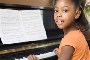 African girl practicing piano